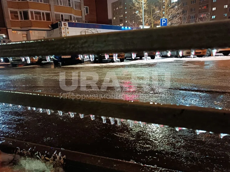 Лед покрыл перила возле подъездов, растения, машины и дороги